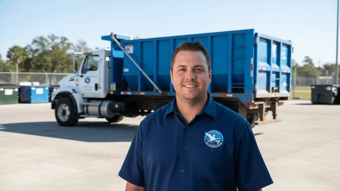 Driveway protection on dumpster delivery in Lakeland, Florida — plywood laid under the wheels and the rails